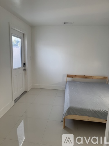 A bedroom with a bed and a window.
