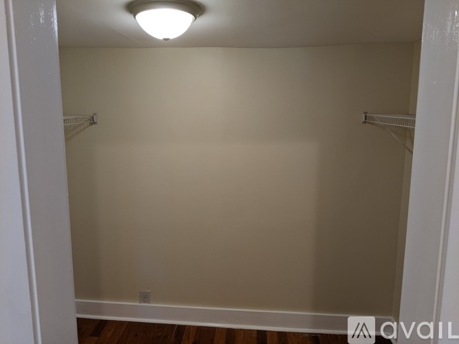 A small, empty room with a light on the ceiling.