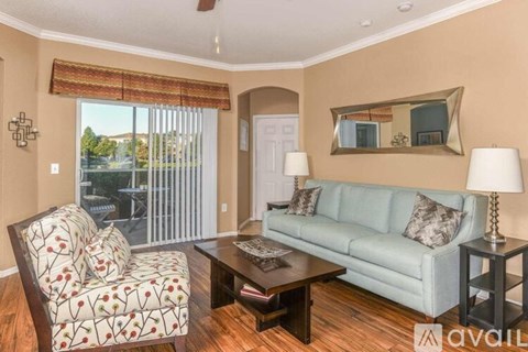 A living room with a couch, chair, and coffee table.