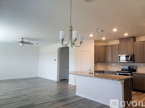 A modern kitchen with wooden cabinets and a white island.