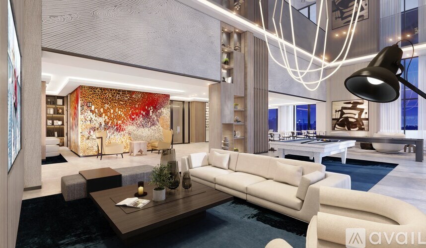 A modern living room with a large coffee table and a large painting on the wall.