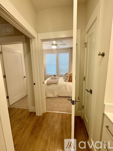 A hallway with a bedroom at the end.