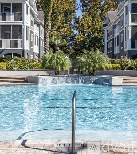 A pool with a waterfall in the middle of it.