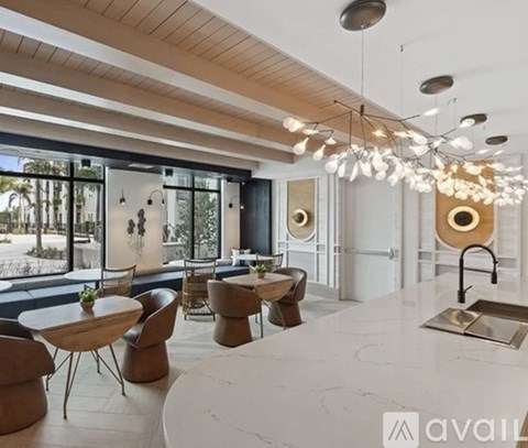 A modern dining room with a large table and chairs.