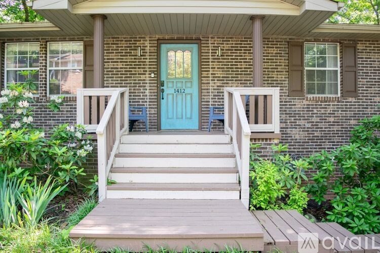 A house with a blue door and a wooden porch.