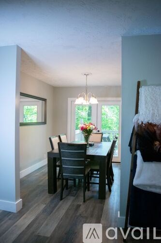 A dining room with a table and chairs.