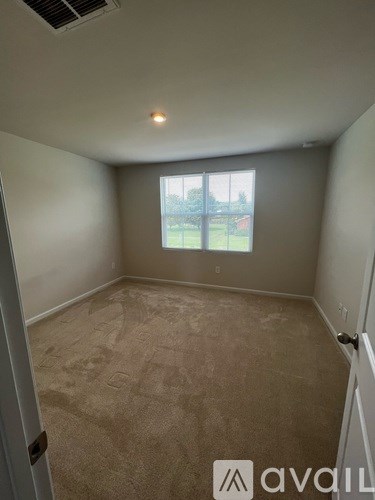 A room with a window and a door.