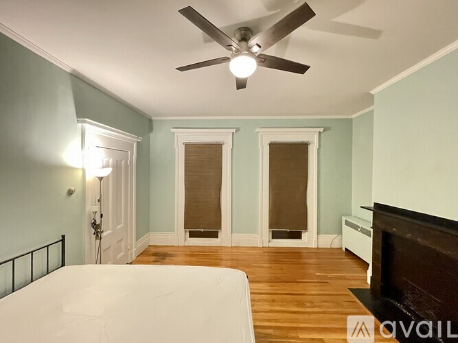 A room with a white door leading to a bedroom.