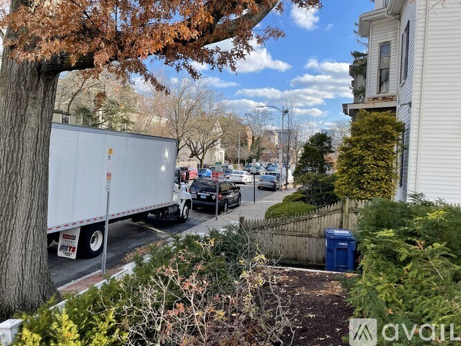 A white truck is parked on the side of a street.