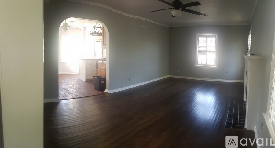 A room with wooden floors and a ceiling fan.