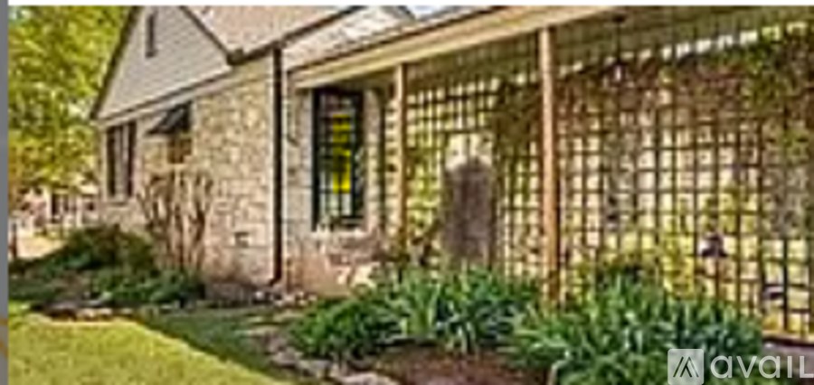 A stone house with a fence in front of it.