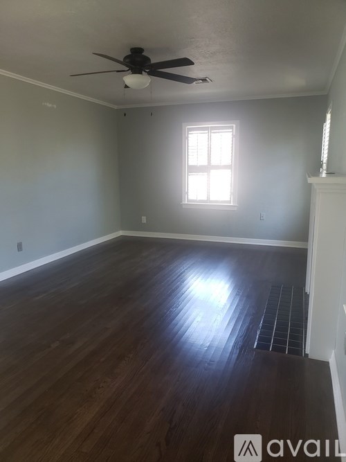 A room with a ceiling fan and a window.