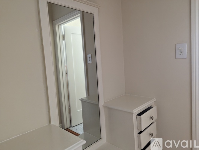 A room with wooden floors and a large window.