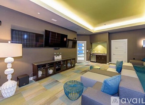 A living room with a grey couch and a television.