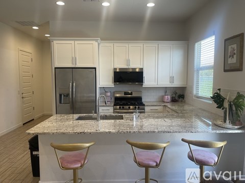 A kitchen with granite countertops and stainless steel appliances.