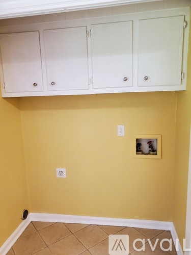 A wall with a picture frame and two switches.