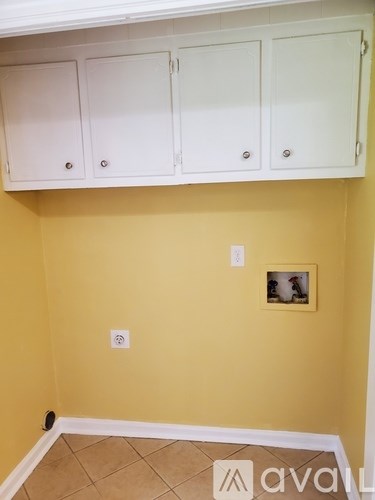 A wall with a picture frame and two switches.
