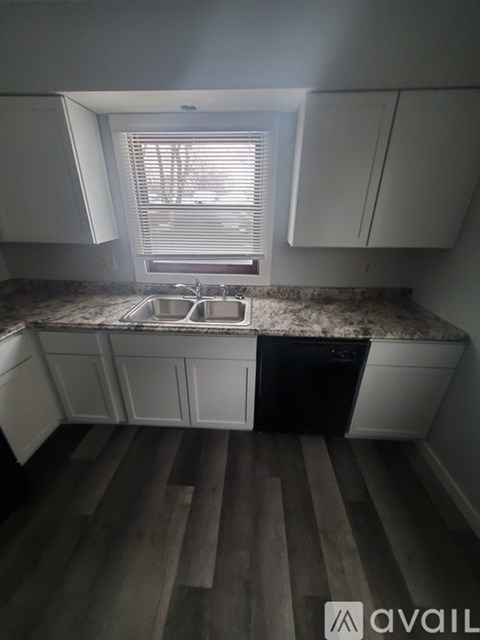 A kitchen with a sink and a window.