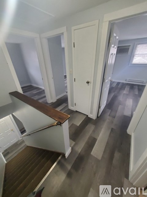 A room with a white door and a wooden counter.