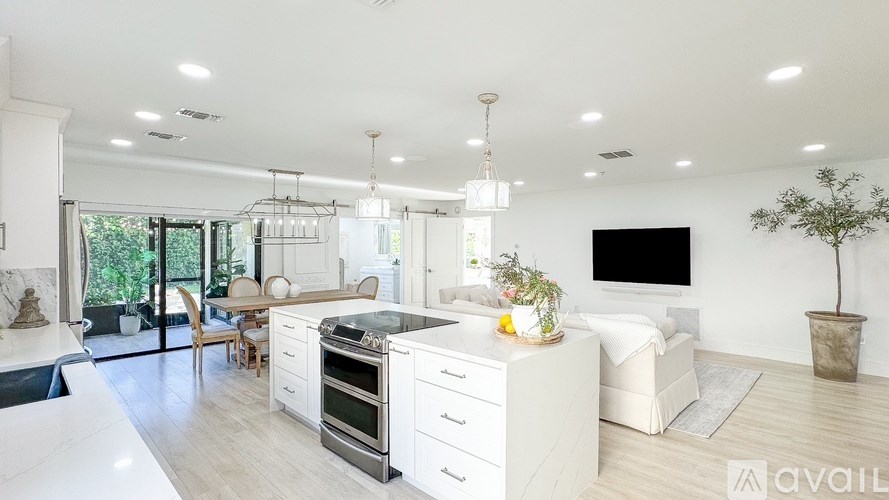 A modern kitchen with white cabinets and a large island.