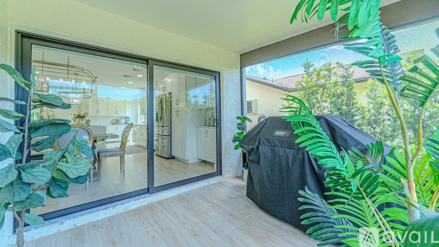 A patio area with a table and chairs is visible through the glass doors.