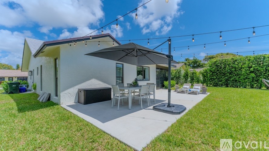 A modern house with a patio and outdoor furniture.