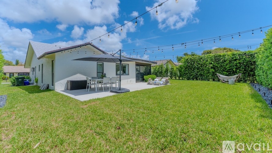 A house with a lawn and a patio area is available for rent.