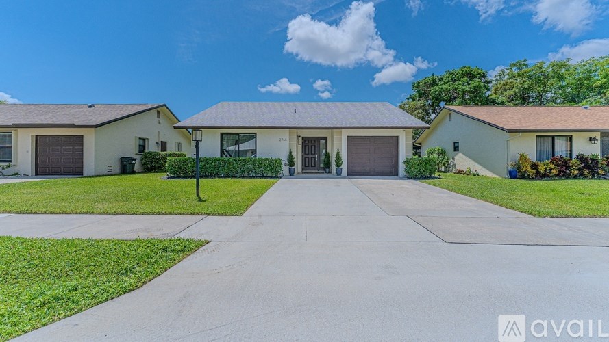 A row of houses with a driveway in the foreground.