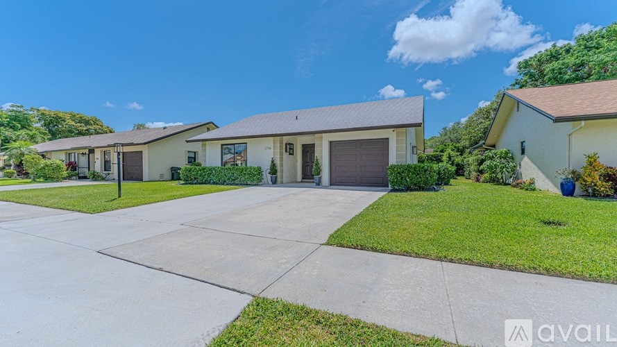 A house with a driveway in front of it is for sale.