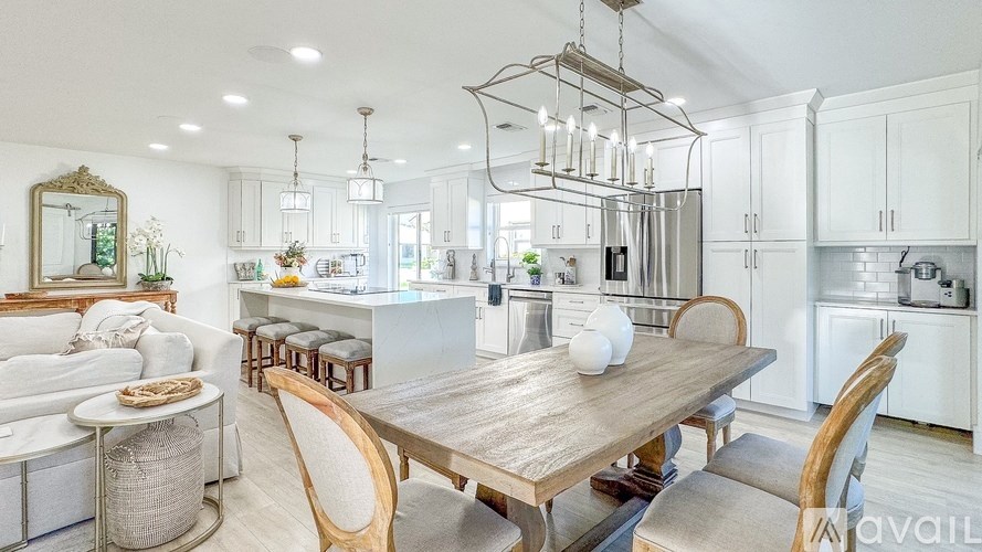 A modern kitchen with a wooden dining table and chairs.