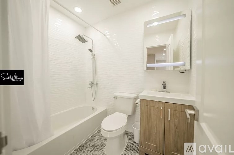 A bathroom with a toilet, sink, and shower.