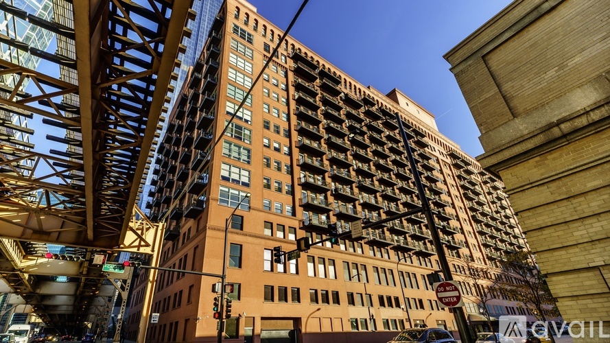 A tall building with many windows is seen from a low angle.