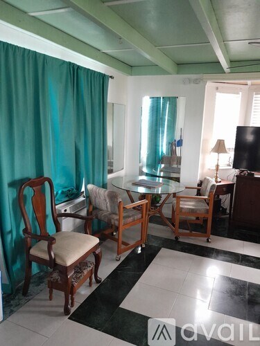 A living room with a glass table and chairs.