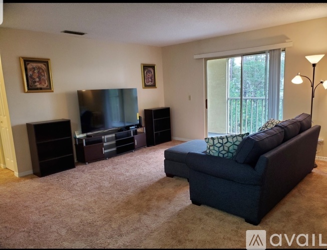 A living room with a blue couch and a television.