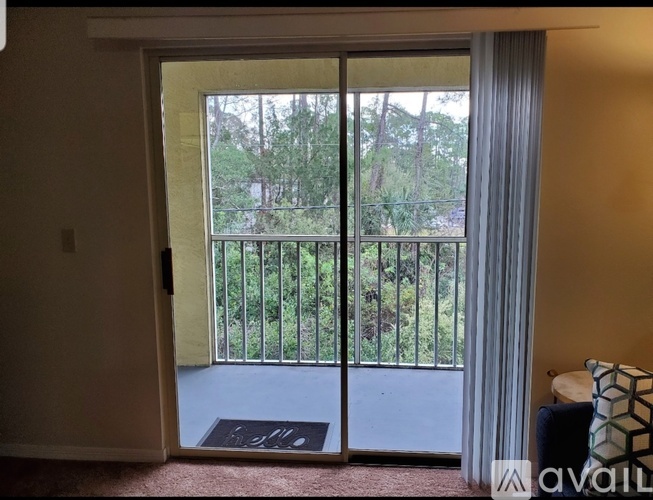 A balcony with a railing and trees in the background.