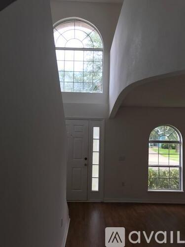 A room with a fan and a window.
