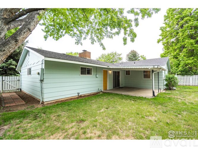 A house with a green front and a yellow door is for sale.
