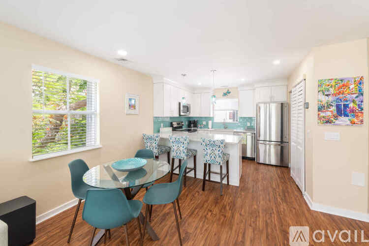 A dining room with a glass table and chairs.