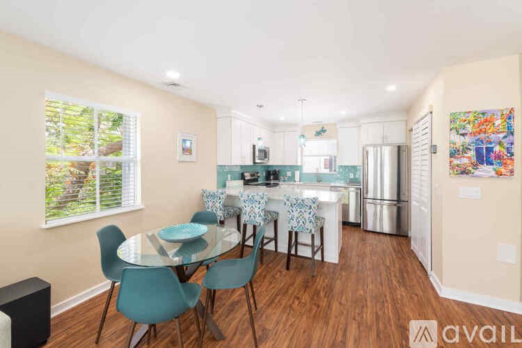 A dining room with a glass table and chairs.