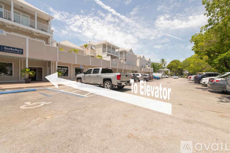 A parking lot with a sign that says "To Elevator".