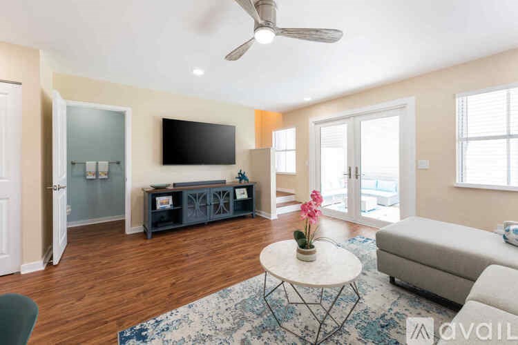 A living room with a television, a sofa, and a coffee table.