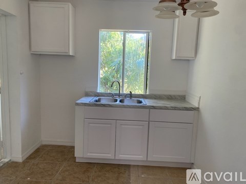 A kitchen with a sink and a window.