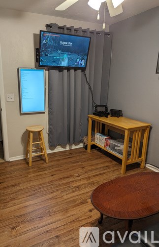 A room with a television and a chair.