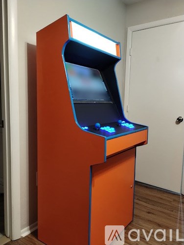 A small arcade game machine with a blue screen and buttons.
