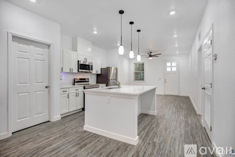 A modern kitchen with white cabinets and a central island.