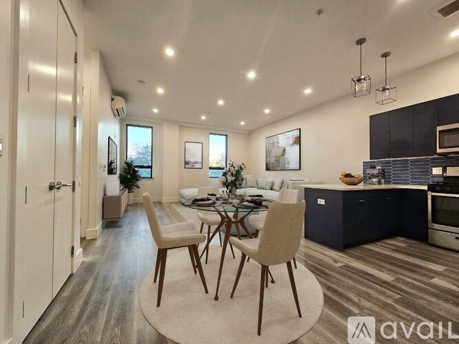 A modern kitchen with a dining table set up in the middle.