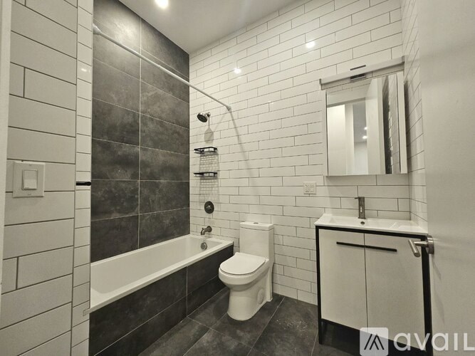 A bathroom with a white toilet, a bathtub, and a sink.