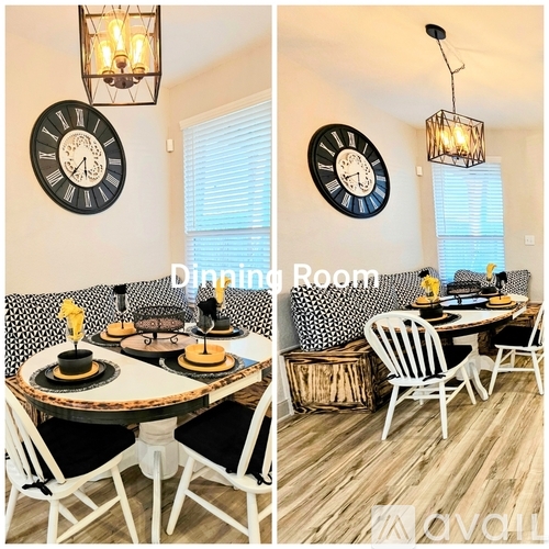 A dining room with a table set for two and two chairs.