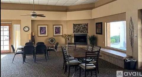 A living room with a fireplace and a dining table set up.