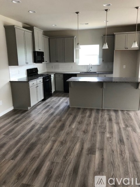 A kitchen with wooden floors and modern appliances.
